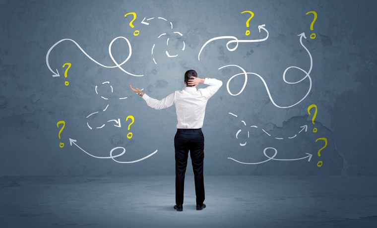 Unsure businessman with question marks