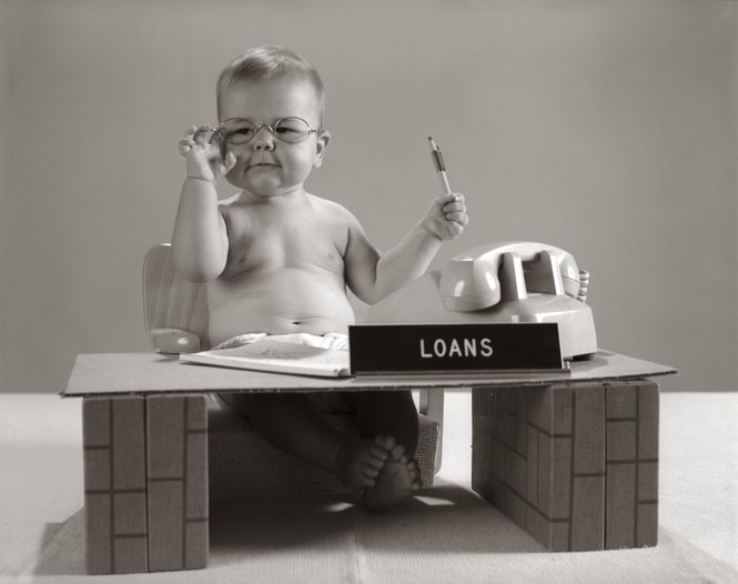 Baby At Desk Playing Loan Officer.