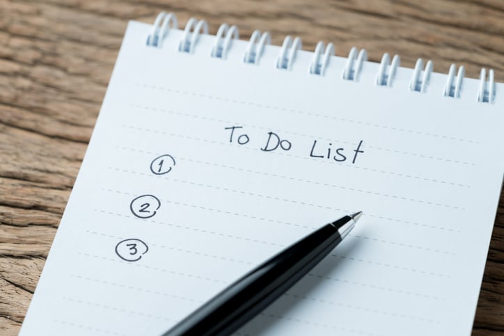 To do or writing tasks priority concept, closed up of list on numbers with pen and headline as To Do List on white paper notepad on wood table in soft tone