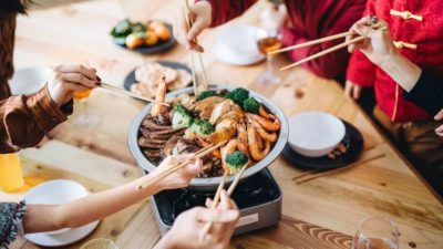 Three generations of joyful Asian family celebrating Chinese New Year