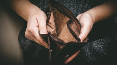 Old empty wallet in hands.