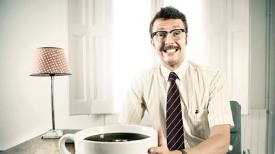 Businessman with oversized coffee cup