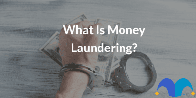 Hand with cuffs on with the text “What Is Money Laundering?” and The Motley Fool jester cap logo
