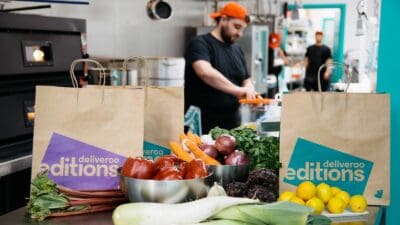 Chef preparing food to be delivered by Deliveroo Editions