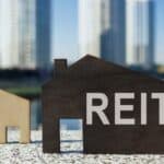 House models and one with REIT - standing for real estate investment trust - written on it.