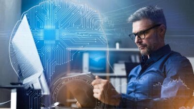 Man reading a tablet, with a wired brain and stock charts in mind