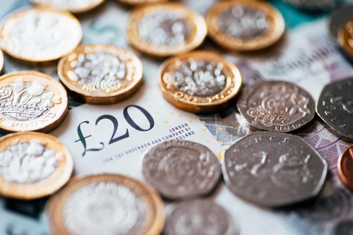 British coins and bank notes scattered on a surface