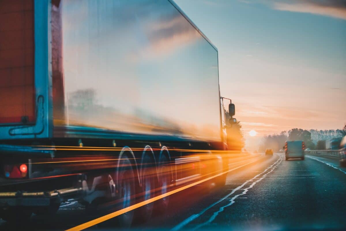 Red lorry on M1 motorway in motion near London