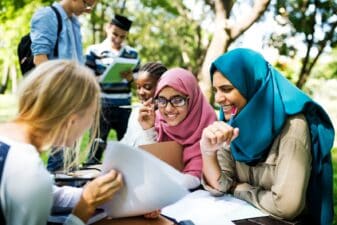 Diverse children studying outdoors