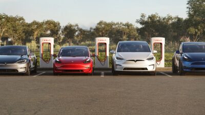 4 Teslas in a parking lot at a charger station